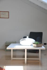 a white table with a bowl on it in a room at Casa Sant Anna in Pordenone