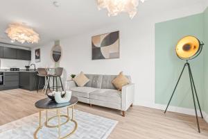 a living room with a couch and a table at Stylish, 2-Bedroom Apartment for 4, Free PaModern 2-Bedroom Flat, Accommodates 4, Free Parking, Wi-Fi, Ideal for Families, City Centrerking, & Wi-Fi, Family-Friendly, City Centre in Liverpool