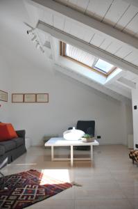 a living room with a couch and a table at Casa Sant Anna in Pordenone +25 photos
