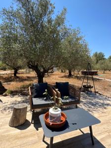 a patio with a couch and a table and a tree at Casa Olivero in Navarrés