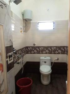 a bathroom with a toilet and a sink at Shiva Homestay Hampi in New Hampi