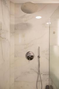 a bathroom with a shower with a glass door at Boutique St Stephens Residence in Kalabaka +24 photos