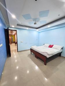 a bedroom with a bed in a blue room at Nivasa-Crafted with love in Ghaziabad
