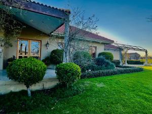 a house with a green yard in front of it at Belle Vallee Guestroom 1 in Wellington