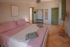 a bedroom with a bed with two towels on it at Dimora delle Acque - Altavista Residence in San Nicola Arcella
