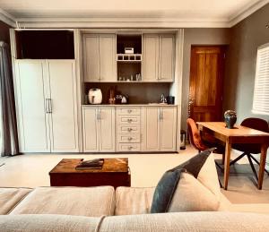 a living room with a couch and a table at Belle Vallee Guestroom 1 in Wellington