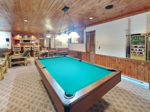 a pool room with a pool table in a house at Tranquil Cove in Sandy Ridge