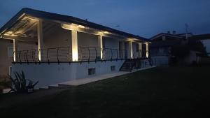 a building with a balcony with lights on it at APPARTAMENTO " Le Terre del Garda " in Castelnuovo del Garda +36 photos