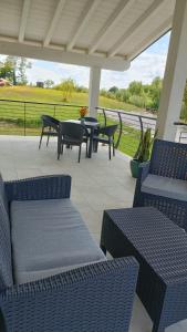a patio with several chairs and tables on a porch at APPARTAMENTO " Le Terre del Garda " in Castelnuovo del Garda