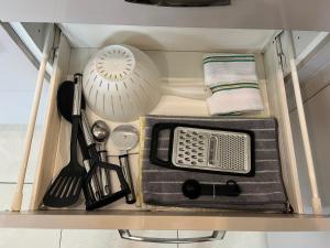 a kitchen utensils are sitting on a shelf at 3BR-Sleeps 6 -Walk to Etihad & AO Arena in Manchester