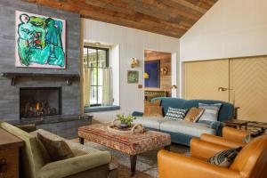 a living room with a couch and a fireplace at The Carly Estate in Carlton