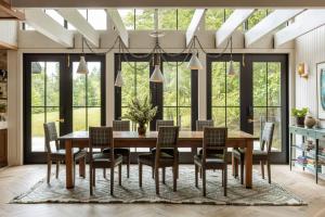 a dining room with a wooden table and chairs at The Carly Estate in Carlton
