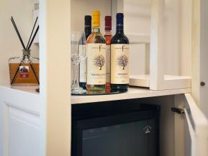 two bottles of wine sitting on a shelf at Casa Tia in Lecce +16 photos