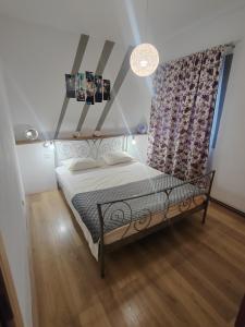 a small bed in a room with a window at Karla in Sveta Nedelja