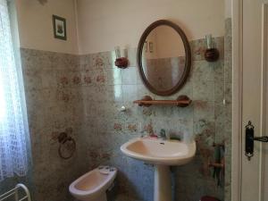 a bathroom with a sink and a mirror at L'Enclos du Château in Courthézon +22 photos