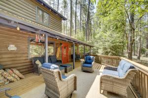 a deck with wicker chairs and chairs on a cabin at Hike and Snow Play! Payson Cabin By Mogollon Rim in Kohls Ranch