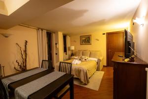 a bedroom with a bed and a television in it at Petite Home in Roccaraso
