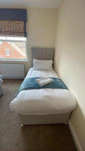 a bed in a small room with a window at Grand View in Scarborough