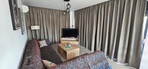a living room with a couch and a television at Centrale apartment in Mastihari