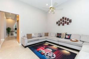 a living room with a couch and a ceiling fan at Sawgrass Estates in Plantation