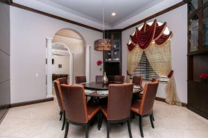 a dining room with a table and chairs at Sawgrass Estates in Plantation