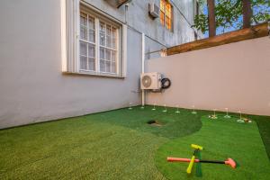 a backyard with a lawn with baseball equipment on it at Condado Home - Private Back yard by PH in San Juan