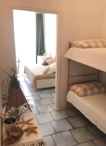a room with two bunk beds and a mirror at Casa Laura a due passi dal mare in Rimini