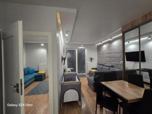 a living room with a couch and a table at Apartament Oaza Jastrzębia Góra in Jastrzębia Góra