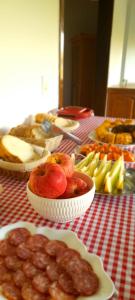 a table topped with bowls of fruit and other foods at Refúgio Rio do Boi in Praia Grande