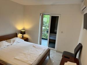 a bedroom with a bed and a sliding glass door at Villa Lopar in Lopar
