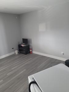 an empty room with a white table and a desk at individual home in Brampton