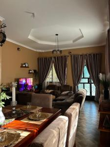 a living room with a couch and a table at Comfort home in Msaranga