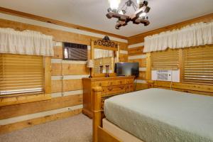 a bedroom with a bed and a flat screen tv at Golfers Getaway Hephzibah Home with Pool Access in Hephzibah +19 photos