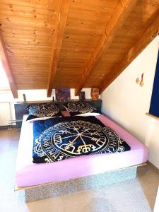 two beds in a room with a wooden ceiling at Welcome to Munich by Martina in Munich