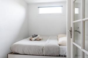 a small bedroom with a bed with a teddy bear on it at Barrière naturelle in Toulouse