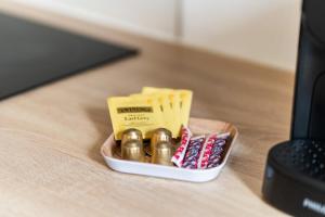 a box of chocolates and toothpicks on a desk at Barrière naturelle in Toulouse +25 photos