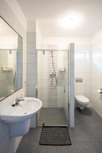a bathroom with a sink and a shower and a toilet at NORDA in Kuźnica +46 photos