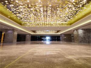 a large lobby with a chandelier and a large room at Tylfull Hotel in Beijing