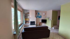a living room with a couch and a window at Casa VACANZE MAGNOLIA in Vercurago +10 photos