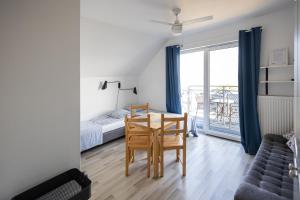 a room with a table and a bed and a window at NORDA in Kuźnica