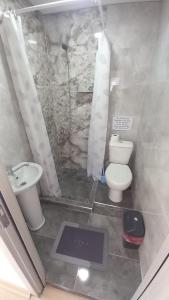 a bathroom with a white toilet and a sink at SKY Apartments in Kruševo