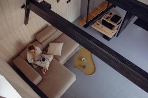 a young girl sitting on a couch with a guitar at Chatička Artoa in Ludvíkov +14 photos