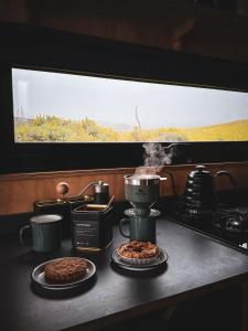 a kitchen counter with two plates of food and a coffee maker at Vega in Llangollen