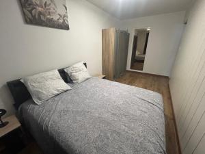a bedroom with a bed with two pillows on it at Résidence Le Soleil Canet Plage , 50m2 climatisé in Canet-en-Roussillon