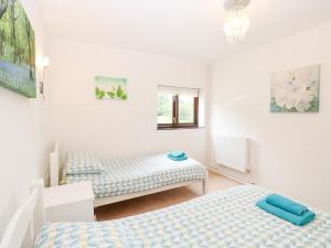 Postel nebo postele na pokoji v ubytování Lowbrook Cottage