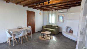 a living room with a table and a green chair at KONAKI Private Villa in Skiros