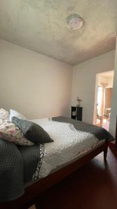 a bed in a bedroom with a ceiling at El Rincón in Oaxaca City