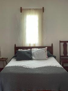 a bedroom with a bed with a window at El Rincón in Oaxaca City +2 photos