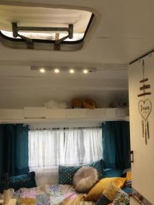 a bedroom with a bed and a window at Glamping du loup garou in Bléré