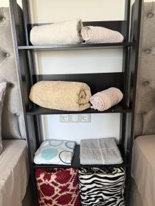 a room with shelves with towels and towels at Studio in Fnidek